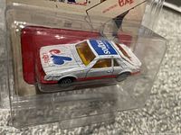 Side angled view of silver diecast 1982 Mustang showing Montreal Expos logos and packaging.