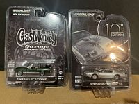 Original packaging of two diecast model cars side by side: 1968 Shelby GT500KR and 1979 Pontiac Firebird T/A