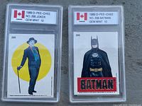 Two graded trading cards in protective slabs: 1989 O-Pee-Chee No. 295 Joker and No. 288 Batman, both graded Gem Mint 10.