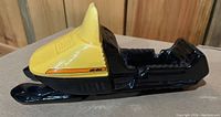 Side perspective showing the overall shape and glossy finish of the Ski-Doo collectible.