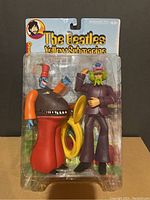Front view of The Beatles Yellow Submarine George figure and Snapping Turk in original blister card packaging