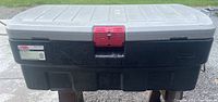 Front view of the black and gray Rubbermaid tool box showing the red locking latch and Rubbermaid label
