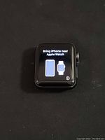 Apple Watch Series 3 powered on, displaying 'Bring iPhone near Apple Watch' setup screen on display.