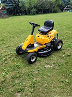 Front-side view showing entire lawn mower on grass background
