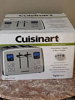 Box showing Cuisinart Stainless Series Countdown Classic 4-Slice Toaster with key features listed including dual control panels, LCD countdown display, 7 shade settings, bagel/defrost/reheat controls.