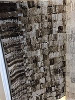 Photo of the rug showing its abstract pattern in shades of brown, beige, gray and taupe.