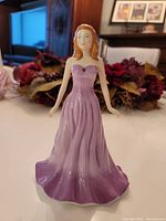 Front view of Royal Doulton February Amethyst lady figurine in purple gown.