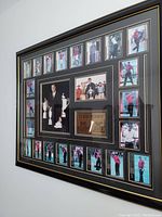 Framed large collage featuring 27 photos of Tiger Woods mounted on wall