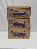 Three stacked boxes of 5Seconds Disinfectant Wipes labeled with branding and product claims