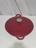 Top view of red enamel skillet with lid and two side handles