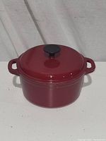 Closed red enamel Dutch oven with lid, showing exterior condition.