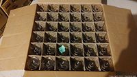Top-down photo showing 36 Arcoroc beer glasses packed upright in a cardboard box with dividers.