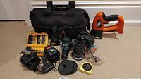 Full set including carrying case, drill, jigsaw, circular saw, router, sander, two chargers, bit sets, safety goggles, and measuring tape.