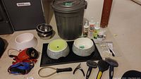 Overview of all items showing dog bowls, leashes, grooming tools, and storage bin grouped together