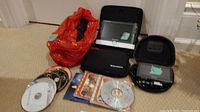 Garmin GPS and Eschenbach Visolux video magnifier with cases displayed side by side