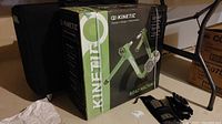 Boxed Kinetic Road Machine bike trainer with case, gloves and splint visible