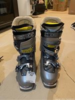 Front view of Salomon ski boots showing four buckles and padded fleece collar.