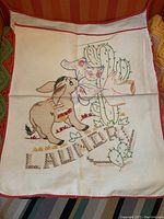 Full view of vintage cotton laundry bag with colorful embroidery of a donkey and cactuses and word 'Laundry'