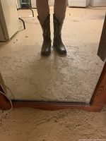 Front view of the boots worn, showing full height and fit on legs.