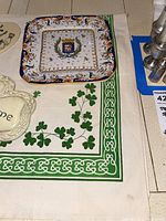 Close-up of square ceramic platter on linen dish towel with shamrocks and Celtic knot border