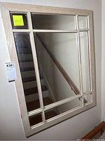 Front view of rectangular wooden framed mirror showing grid style dividers