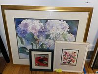 Three framed prints including large hydrangea floral, medium floral bouquet, and small still life with dishes