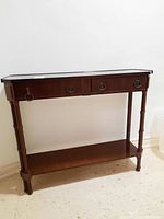Front view of wood console table showing two drawers with metal ring pull handles and lower shelf.