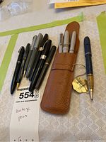 Group shot of eight vintage pens and pencils including three in leather pouch