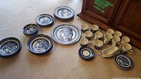 Full set of Churchill Blue Willow china plates, cups, and gravy boat arranged on carpet