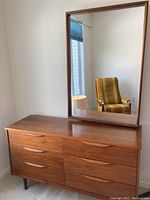 Full front view of six-drawer dresser with mirror mounted on top