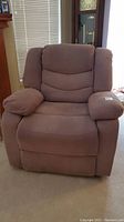 Front view of a light brown fabric electric recliner chair with thick padded armrests and cushioned backrest.
