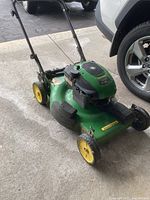 Front-left angle showing deck, wheels, handle
