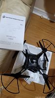 Holy Stone HS100 drone with instruction manual showing model and camera details