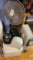 Wide shot of the lot showing the floor fan, ottoman, and heaters grouped together for scale and identification.