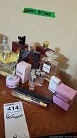 Photo showing various perfume bottles and boxes on wooden surface.