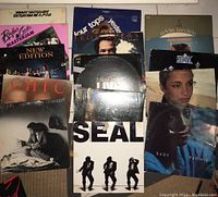Overview of 15 vinyl albums showing cover art from various artists.