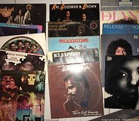 Photo showing 15 vinyl record album covers featuring various artists including The Mandrill, Ray, Goodman & Brown, Isaac Hayes, Bloodstone, and Diana Ross.