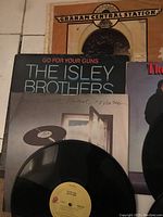 Photo of several vinyl albums including The Isley Brothers 'Go For Your Guns' and Earth, Wind & Fire album.