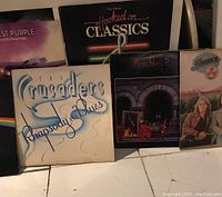 Vinyl records including The Crusaders 'Rhapsody and Blues', Rush albums, and others arranged side by side