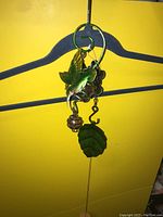 Photo of decorative hanging bell with green bird and leaf design