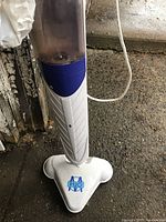 Front view of H2O mop steamer standing upright showing its triangular mop head with the H2O logo