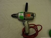 Front angled view of the Black & Decker reversing drill showing 1/2 inch chuck, handle grip, power cord, brand label and condition.