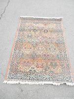 Full view of the Gabbeh rug showing the floral and geometric patterns and fringed edges.