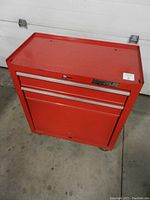 Red Waterloo 2 drawer rolling tool chest, showing closed front view with brand label and caster wheels.