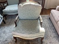 Front view of the custom upholstered bergere chair showing seat cushion and back with swirl pattern.
