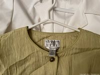 Talbots olive-green cardigan on white hanger with Talbots Collection label size 10