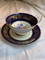 Side angle view of tea cup and saucer showing design and condition