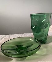 Large green dimpled glass vase and matching dish shown side by side.