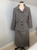 Full front view of the long-sleeve checkered knit suit on a mannequin showing the coat-style top and skirt.