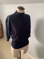 Front view of vintage navy Max Mara sweater on mannequin, showing fit and style.
